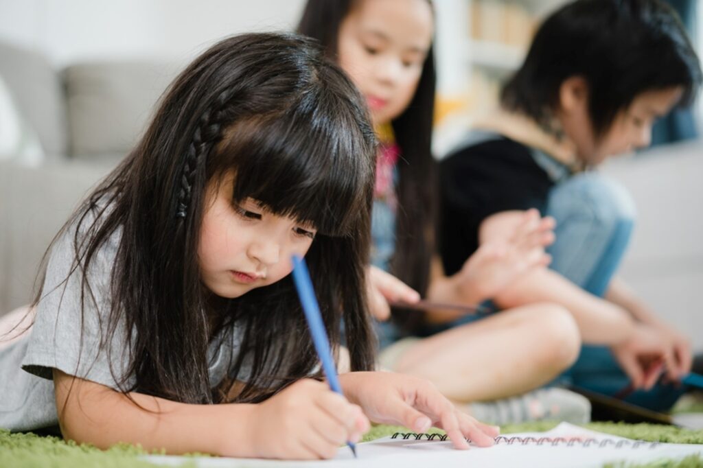 A student develops her skills in kindergarten.